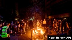 Demonstrators burn garbage in Oakland, Calif., on May 29, 2020, protesting George Floyd's death.