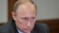 Russian president Vladimir Putin takes part in a government meeting at the Bocharov Ruchei state residence in Sochi, March 28, 2013. 