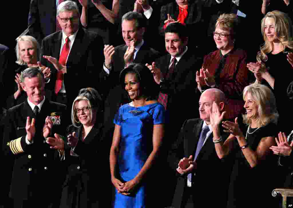 First lady Michelle Obama is applauded prior to the State of the Union. Front row, from left are, Adm. William McRaven, Jackie Bray, Obama, Retired Capt. Mark Kelly, Jill Biden and Sgt. Ashleigh Berg. (AP)