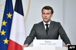 FILE - French President Emmanuel Macron speaks during a press conference at the Elysee Presidential Palace, in Paris, July 9, 2021.