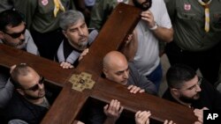 FILE Christians walk the Way of the Cross procession that commemorates Jesus Christ's crucifixion on Good Friday, in the Old City of Jerusalem, March 29, 2024.