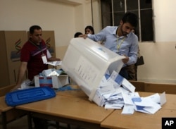 Election officials count ballots after the polls closed in the controversial Kurdish referendum on independence from Iraq, in Irbil, Iraq, Sept. 25, 2017.