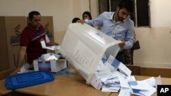 FILE - Iraqi election officials count ballots in Irbil.