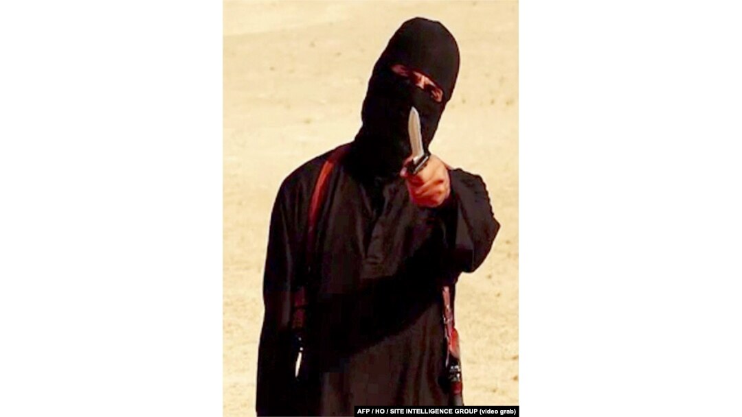 FILE - An image taken from a video released by the Islamic State group purportedly shows a masked militant holding a knife and gesturing as he speaks to the camera before beheading U.S. freelance writer Steven Sotloff.