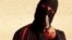FILE - An image taken from a video released by the Islamic State group purportedly shows a masked militant holding a knife.