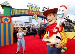 People in costume as Bo Peep, Woody and Forky are seen at the premiere for "Toy Story 4" in Los Angeles, California, U.S., June 11, 2019