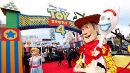 People in costume as Bo Peep, Woody and Forky are seen at the premiere for 
