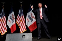 Republican presidential candidate Donald Trump gives thumbs-up as he arrives to speak at a campaign a rally in Clive, Iowa, Sept. 13, 2016.