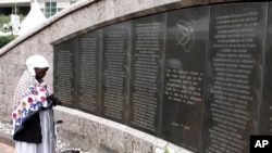 FILE - A woman prays for the victims at the memorial site in Nairobi, Kenya, Aug. 7, 2013 during events marking the 15th anniversary of the bombing of the U.S. Embassy in the city. 