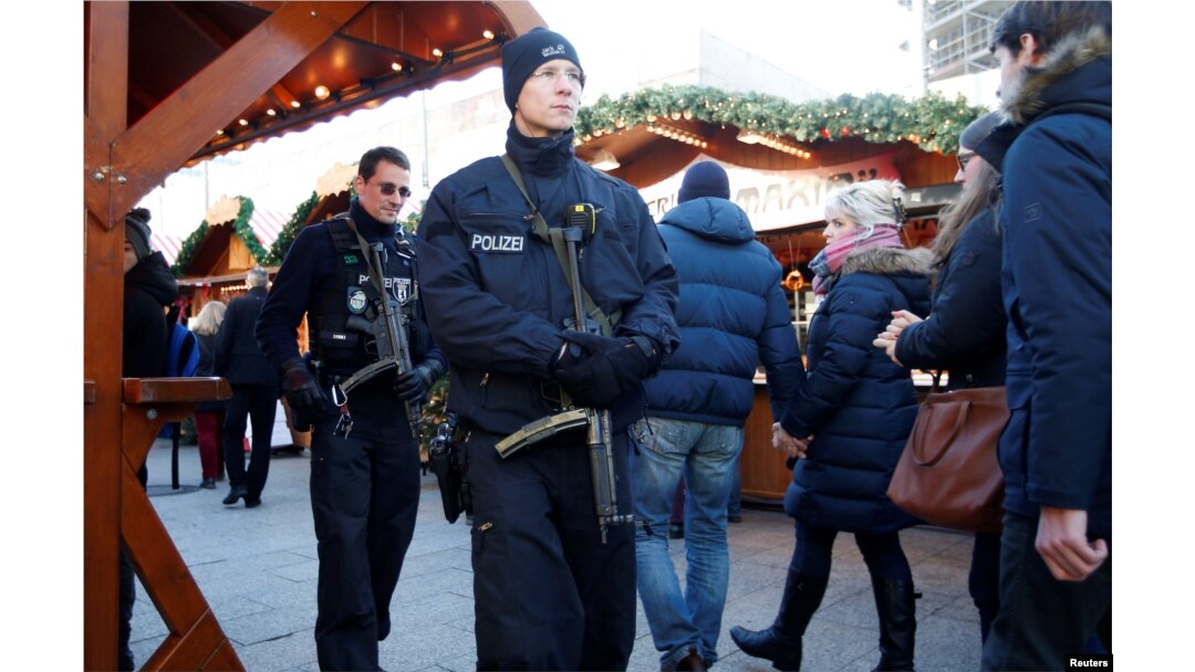 German police patrol with submachine guns at the Christmas market at Breitscheid square in Berlin, Dec. 30, 2016, following an attack by a truck which ploughed through a crowd at the market.