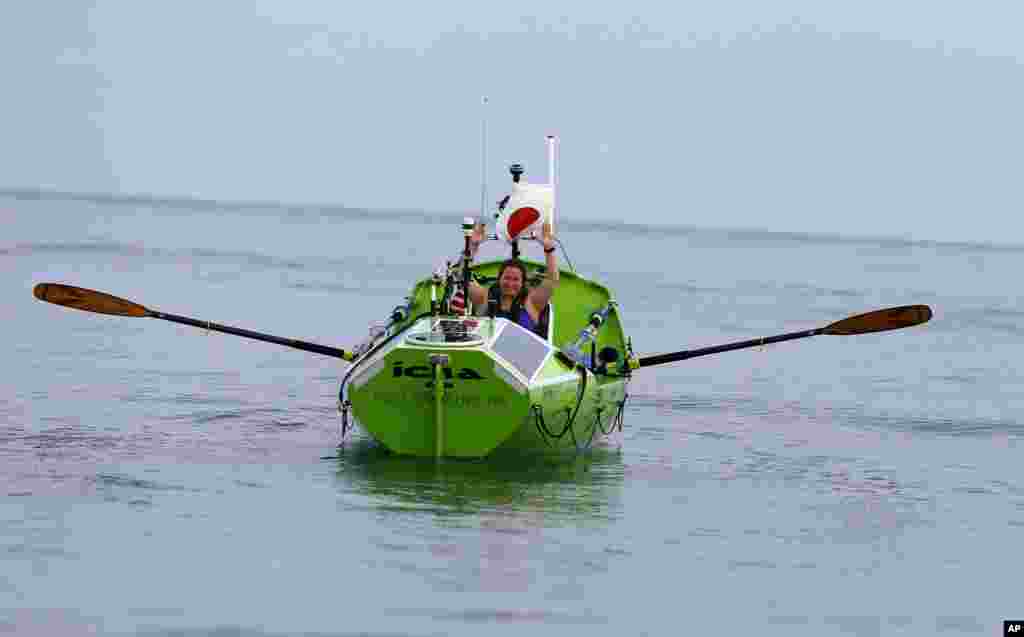 American rower Sonya Baumstein from Orlando, Florida, waves as she leaves Choshi Marina in Choshi, a port east of Tokyo, headed for San Francisco. Baumstein hopes to finish the 9,600-kilometer (6,000-mile) journey by late September and become the first woman to row solo across the Pacific in the 23-foot (7-meter) -long vessel.