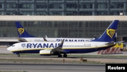 FILE - Two Boeing 737-8AS passenger aircrafts of Ryanair airline taxi on a runway at Malaga-Costa del Sol airport, in Malaga, Spain, May 3, 2024. 