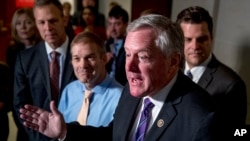 Republican Congressmen, from left, Scott Perry of Pennsylvania, Jim Jordan of Ohio, ranking member of the Committee on Oversight Reform Mark Meadows and Matt Gaetz of Florida speak to reporters on Capitol Hill in Washington, Oct. 8, 2019. 