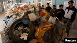 FILE - Jordanian students tour an exhibition on the amount of plastic waste in the Gulf of Aqaba and in the world's oceans in Amman, Nov. 19, 2014. 