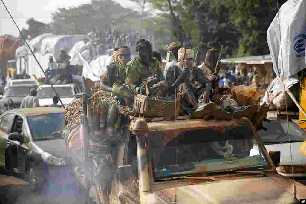 At PK12 Chadian troops escort thousands of Muslim residents from Bangui and Mbaiki, fleeing the Central African Republic capital Bangui in a mass exodus using cars, pickups, trucks, lorries and motorcycles on Friday Feb. 7, 2014. 