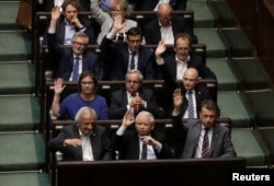 FILE - Leader of Law and Justice (PiS) party Jaroslaw Kaczynski votes on a contested Supreme Court law in Warsaw, Poland, July 20, 2017.