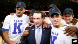 Duke head coach Mike Krzyzewski celebrates with his players after his 1,000th career win in an NCAA college basketball game against St. John's at Madison Square Garden in New York Jan. 25, 2015.