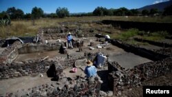 Men work at one of the multi-family apartment compounds at La Ventilla, one of the most extensively excavated neighborhoods in the ancient city of Teotihuacan, November 7, 2019. (REUTERS/Gustavo Graf)