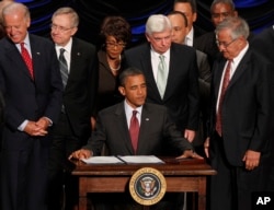 FILE - President Barack Obama gets ready to sign the Dodd-Frank Wall Street Reform and Consumer Protection Act at the Ronald Reagan Building in Washington, July 21, 2010.