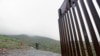 Border Patrol agent Vincent Pirro looks on near where a border wall ends that separates the cities of Tijuana, Mexico, and San Diego, Feb. 5, 2019, in San Diego. 