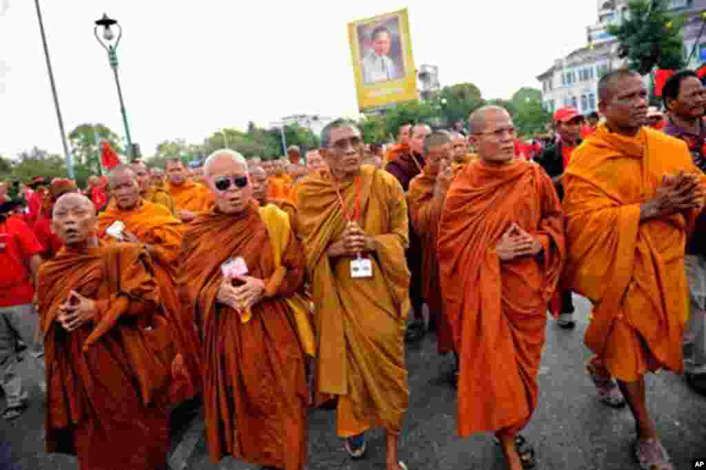 Buddhist monks join red-shirted supporters of deposed Thai premier Thaksin Shinawatra during an anti-government protest in downtown Bangkok on March 16, 2010.