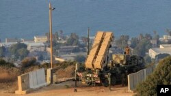 FILE - Israeli soldiers are seen next to a Patriot rocket interceptor battery deployed in the northern Israeli city of Haifa.