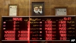 FILE - Various rates and prices for currencies and gold coins are displayed at an exchange bureau in Tehran, Iran, Aug. 21, 2019. 