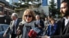 United Nations Special Rapporteur Agnes Callamard, surrounded by members of the media, walks around the Saudi Consulate, background, in Istanbul, Jan. 29, 2019. Callamard was investigating the death of Saudi journalist Jamal Khashoggi. 