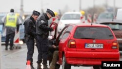 French police conduct a control at the French-German border in Strasbourg, France, to check vehicles and verify the identity of travelers as security increases after last Friday's deadly attacks in Paris, Nov. 20, 2015.