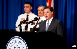 Carver County Attorney Mark Metz, right, announced April 19, 2018 in Chaska, Minnesota, that no criminal charges will be filed in the death of musician Prince in 2016.