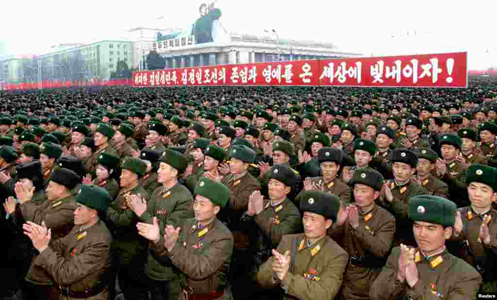 North Koreans celebrate the successful launch of the Unha-3 rocket at Kim Il Sung square in Pyongyang December 14, 2012. The sign reads: "Let's glorify dignity and honor of great people of Kim Il Sung and of Korea of Kim Jong Il in the world!"