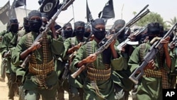 An August 2011 photo shows Al-Shabab fighters marching with their guns during military exercises on the outskirts of Mogadishu.