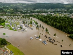 Parts of Dokka are flooded after the Dokka River overflowed its banks as Storm Hans hit Norway with heavy rain on Aug. 9, 2023.