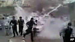 In this image obtained by AFPTV from YouTube on March 23, 2011, Syrian protesters run for cover from tear gas during a recent but undated demonstration in the southern town of Daraa. AFP could verify that the pictures were shot in Daraa.