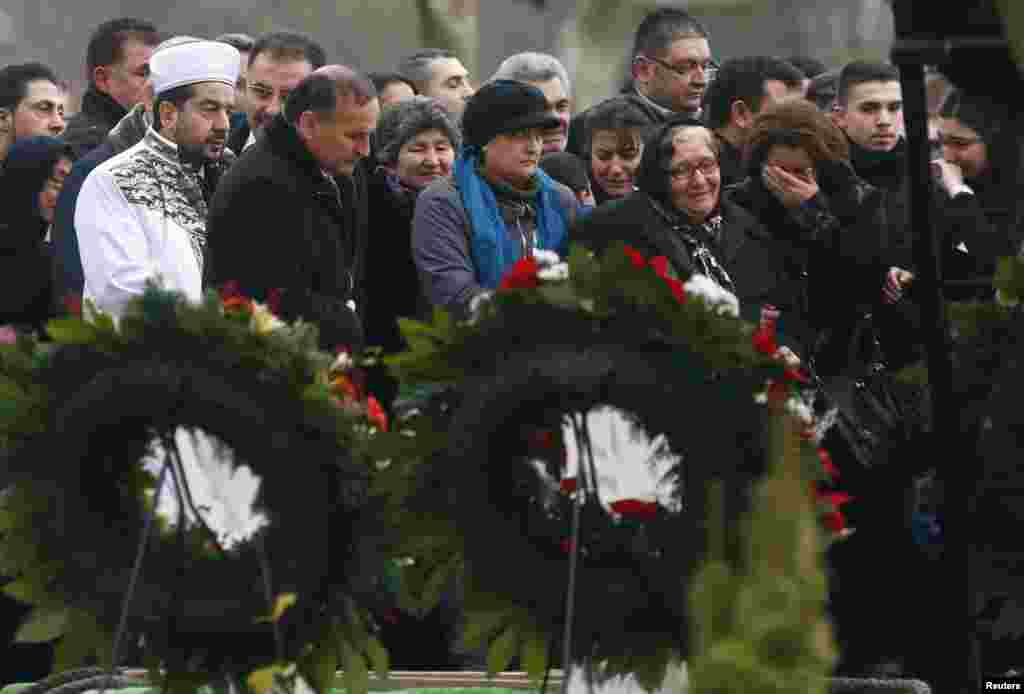 People cry during the burial of Tugce Albayrak at a cemetery in Bad Soden-Salmuenster, December 3, 2014.