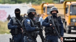 Kosovo special police officers are pictured as hundreds of Kosovo Serbs protest against a government ban on entry of vehicles with Serbian registration plates in Jarinje, Kosovo, September 21, 2021. REUTERS/Laura Hasani/File Photo