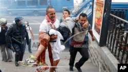 Injured pro-Palestinian protester evacuated as clashes erupt at Place de La Republique during a banned demonstration in support of Gaza, Paris, July 26, 2014.