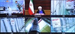 A handout picture provided by the Iranian presidential office on April 10, 2021, shows a videoconference with views of devices at Iran's Natanz uranium enrichment plant, and Iranian President Hassan Rouhani speaking, in the capital Tehran.
