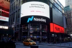 The NASDAQ market site displays an AirBnb sign on their billboard on the day of their IPO in Times Square in the Manhattan borough of New York City, New York, U.S., December 10, 2020.