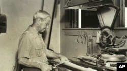 Bud Hillerich making a bat, turning it by hand. A computer controlled lathe now turns out Louisville Sluggers every few seconds.