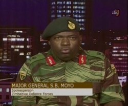 In this image made from video, Major Gen. S.B. Moyo, Spokesperson for the Zimbabwe Defense Forces addresses to the nation in Harare, Zimbabwe, Nov. 15, 2017.