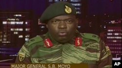 FILE: In this image made from video, Major Gen. S.B. Moyo, Spokesperson for the Zimbabwe Defense Forces addresses to the nation in Harare, Zimbabwe, Nov. 15, 2017. 