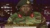 In this image made from video, Major Gen. S.B. Moyo, Spokesperson for the Zimbabwe Defense Forces addresses to the nation in Harare, Zimbabwe, Nov. 15, 2017. 