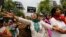 Supporters of India's main opposition Bharatiya Janata Party (BJP) shout slogans as they march towards the residence of the chief of India's ruling Congress party Sonia Gandhi during a protest rally in New Delhi Apr. 21, 2013.
