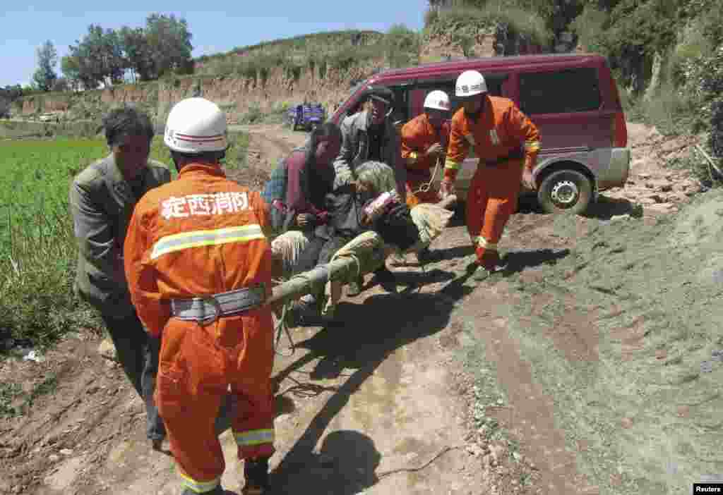 Firefighters on the scene in Minxian county, Dingxi, Gansu province, China, July 22, 2013.