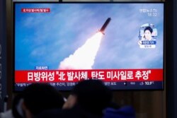 FILE - People in Seoul, South Korea, watch a TV broadcasting file footage for a news report on North Korea firing an unidentified projectile, Nov. 28, 2019.