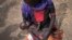 FILE - Adel Bol, 20, cradles her 10-month-old daughter at a food distribution site in Malualkuel in the Northern Bahr el Ghazal region of South Sudan, April 5, 2017.