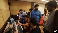 Journalists work inside a media center set up by Jammu and Kashmir authorities in Srinagar, Indian-controlled Kashmir, Aug. 18, 2019. 