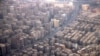 FILE - An aerial view of traffic and buildings, as pictured through the window of an airplane, in Cairo, Feb. 6, 2025.