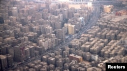 FILE - An aerial view of traffic and buildings, as pictured through the window of an airplane, in Cairo, Feb. 6, 2025.